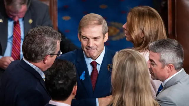 Republican lawmaker from Ohio Jim Jordan (C) chats with other lawmakers while awaiting another vote on the House floor for Jordan to be the next Speaker of the House in the US Capitol