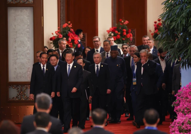 President Xi walks into the hall to attend the opening ceremony other delegates