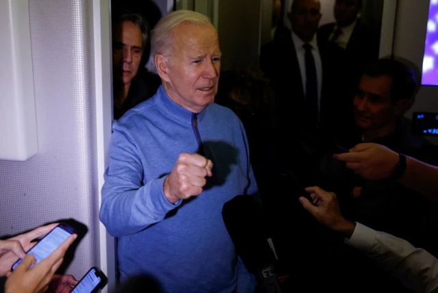 Joe Biden talks to reporters onboard Air Force One