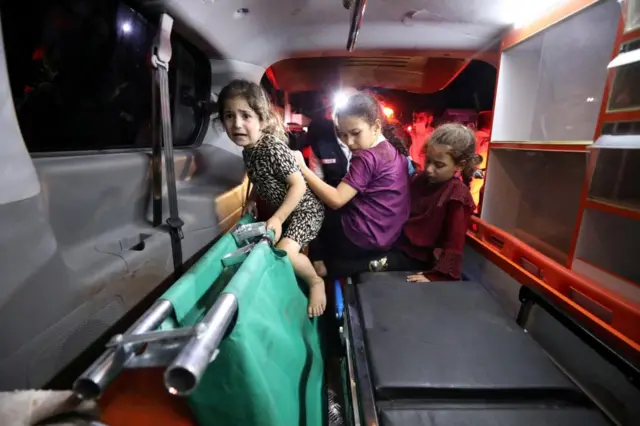 Girls being moved onto an ambulance