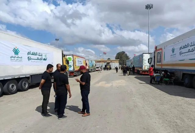 Trucks carrying humanitarian aid lined up on the Egyptian side of the Rafah crossing