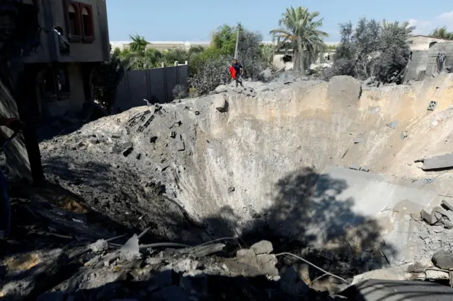 A view of a very large crater at the site of an Israeli air strike