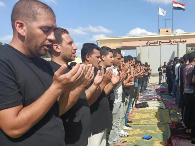 Egyptian volunteers gather to pray after the blast at a Gaza hospital on 17 Oct