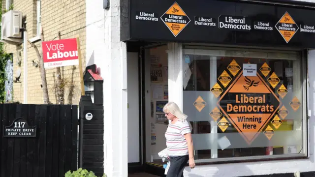 A woman walking past the Liberal Democrats' office in Flitwick