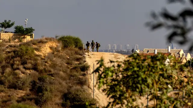 Israeli soldiers walk in Sderot on the Israel-Gaza border