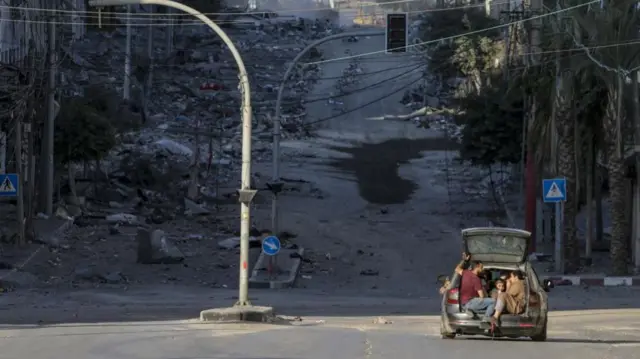 Residents of Gaza City evacuate in a car as Israel continues airstrikes of the Gaza strip