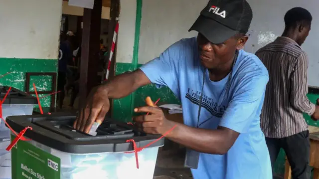 A man casts his vote during the presidential and general election Oluremi Tunubu Public School in Mount Barclay community, outside Monrovia, Liberia, 10 October 2023