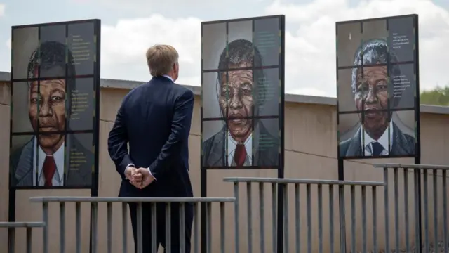 King Willem-Alexander of the Netherlands looks at images of Nelson Mandela during a visit to the Apartheid Museum in Johannesburg, South Africa, 18 October 2023.