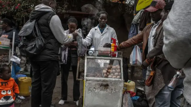 treet Vendors sell snacks to pedestrians at Central Business District (C.B.D) in Nairobi