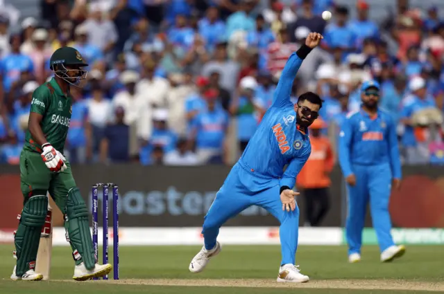 India's Virat Kohli bowling in Cricket World Cup