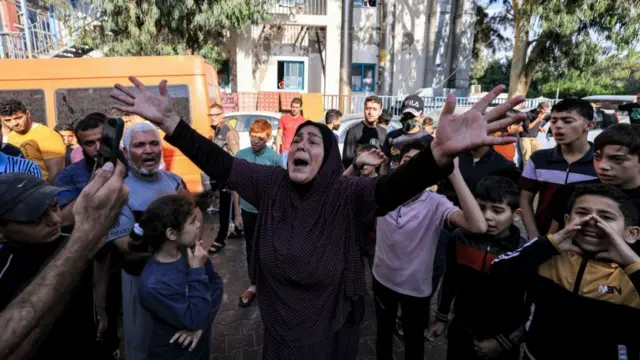 People gathered outside the Al Ahli hospital, where hundreds of civilians died in an explosion