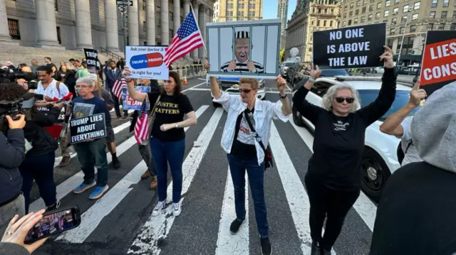 Protesters gathered outside the court before Trump's arrival