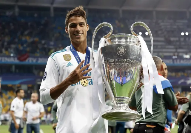 Raphael Varane holds the Champions League trophy