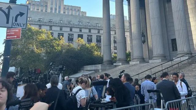 Reporters gather outside the court this morning