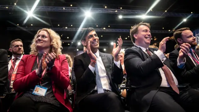 Rishi Sunak applauds from the audience at the Tory party conference