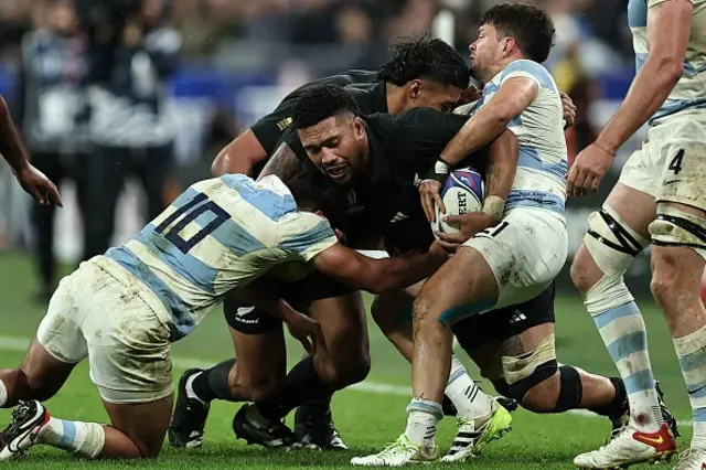 Ardie Savea is tackled by Argentina's fly-half Santiago Carreras