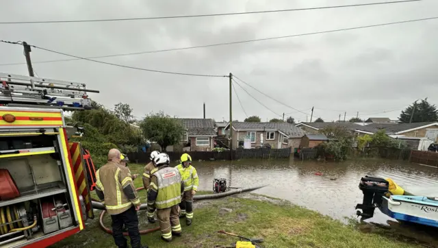 Firefighters pumping water in St Osyth