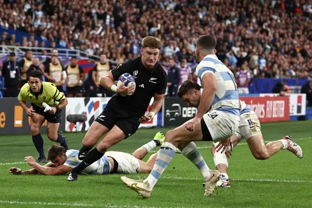 New Zealand's inside centre Jordie Barrett runs on his way to scoring a try