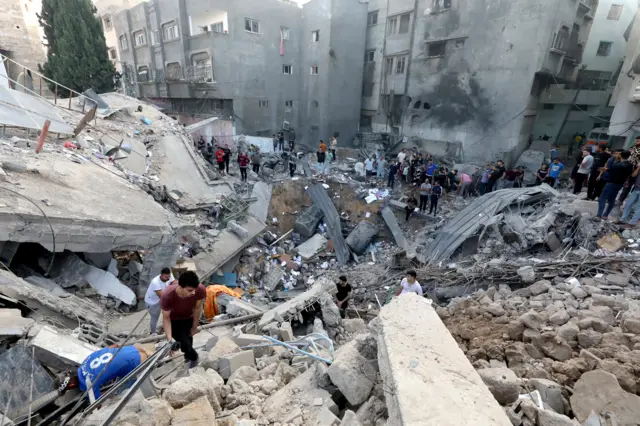 Palestinians search the destroyed annex of the Greek Orthodox Saint Porphyrius Church, the oldest church still in use in Gaza