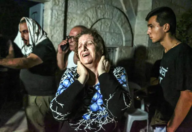 A woman cries at the Church of Saint Porphyrius in Gaza City