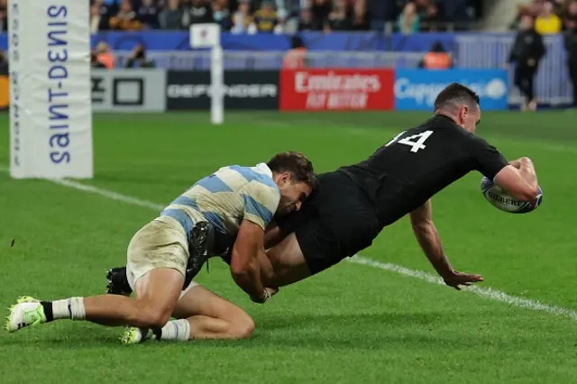 New Zealand's right wing Will Jordan dives across the line to score