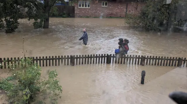 People making their way through floodwater