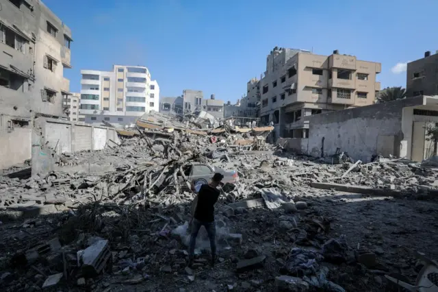 A man inspects the rubble of a destroyed building in Gaza City