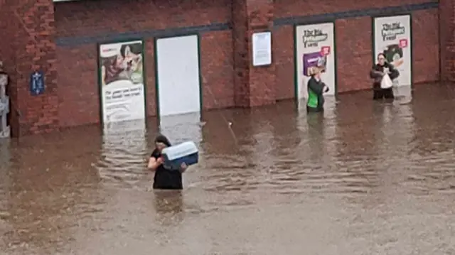 Staff rescuing animals from flooding at Pets at Home