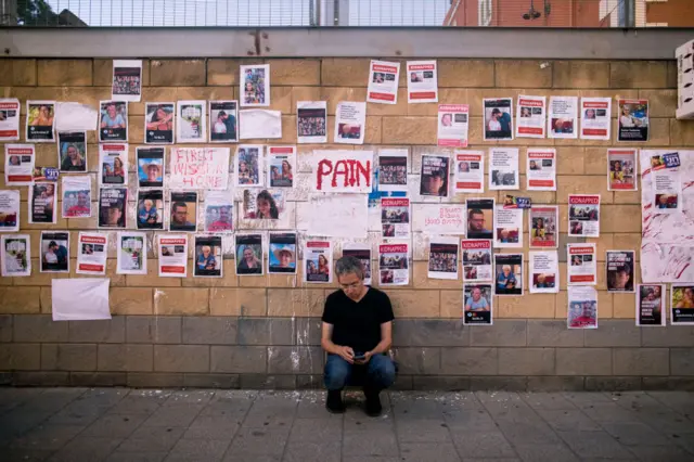 A wall in Tel Aviv with photos of people kidnapped or who've gone missing after the Hamas attack