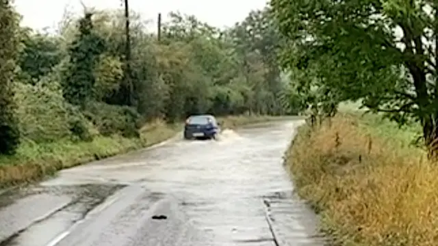 Vehicle passes through standing water on Barking Road in Needham Market.