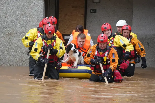 Members of the emergency services help local residents to safety in Brechin, Scotland, as Storm Babet batters the country.