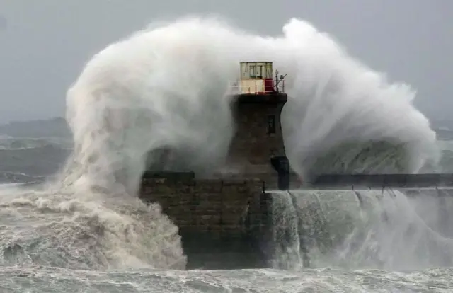 Waves caused by Storm Babet crash against the lighthouse in South Shields