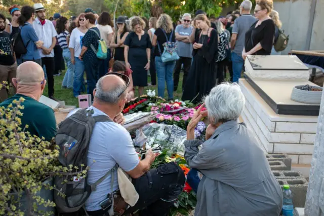 People mourn for one of the victims killed by Hamas attackers who infiltrated his home in the Israeli kibbutz of Be'eri last week