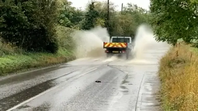 Vehicle passes through standing water on Barking Road in Needham Market.