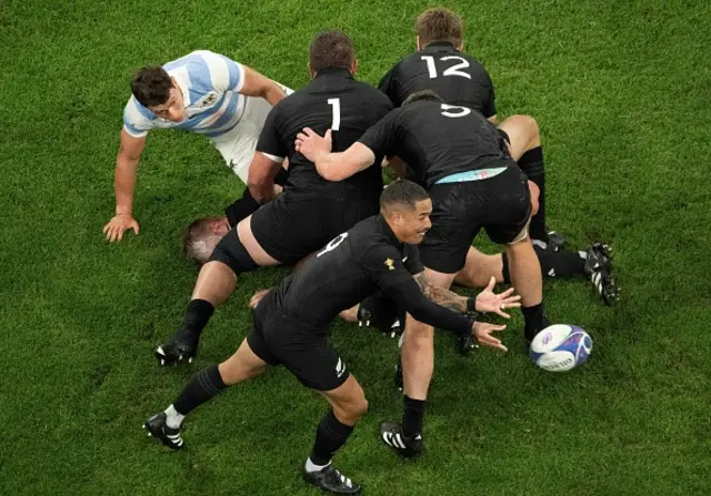 New Zealand's scrum-half Aaron Smith passes the ball