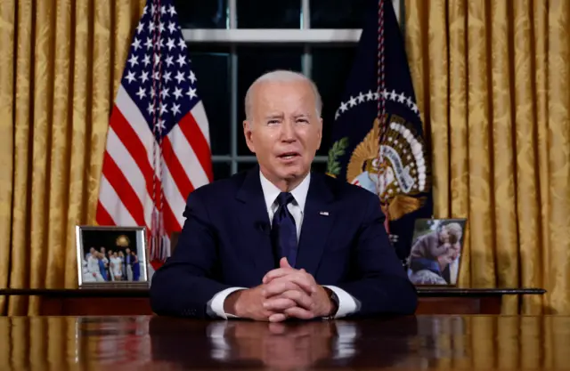 Joe Biden sitting at a desk