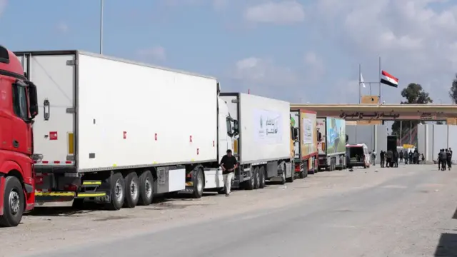 Trucks of a humanitarian aid convoy are parked outside border gate between Egypt and Gaza. Photo from 19 October