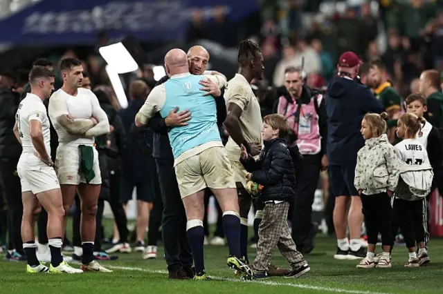 England's head coach Steve Borthwick hugs Dan Cole