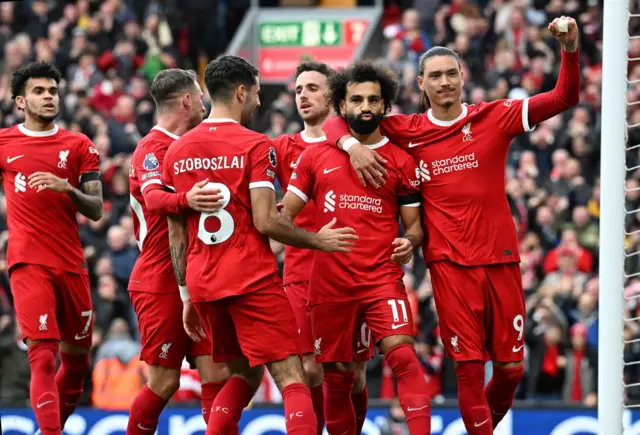 Mohamed Salah of Liverpool celebrates after scoring the opening goal during the Premier League match between Liverpool FC and Everton FC