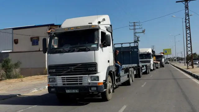 Empty trucks are parked on the side of the road on the Gaza side of the Rafah border crossing