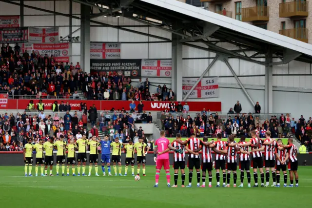 Players, fans and match officials observe a minutes silence in remembrance of the victims of last weekends attacks