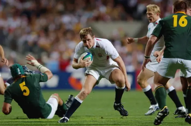 Will Greenwood of England avoids the tackle of Victor Matfield