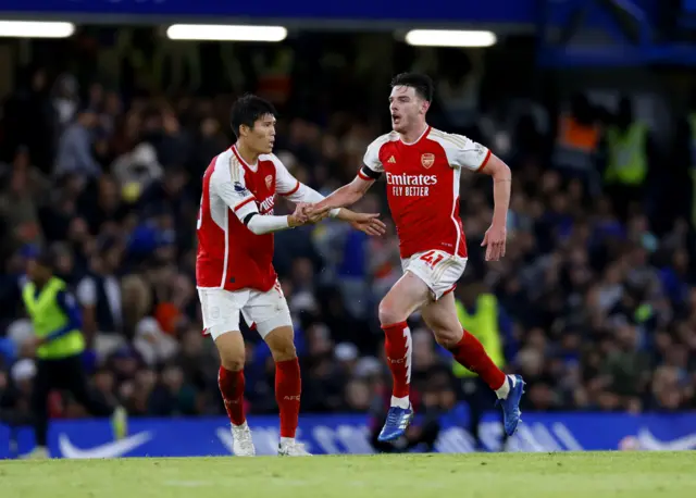 Rice high fives Tomiyasu after scoring for Arsenal.