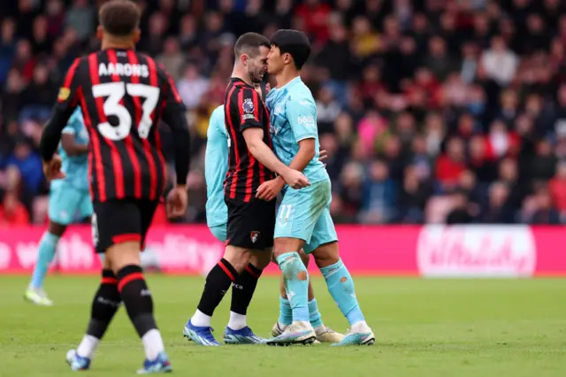 Lewis Cook of AFC Bournemouth clashes with Hwang Hee-Chan of Wolverhampton Wanderers,