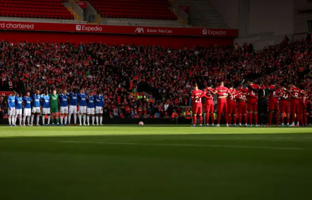 Players holding a minute's silence