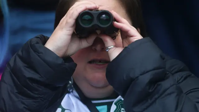 Plymouth fan looks through binoculars