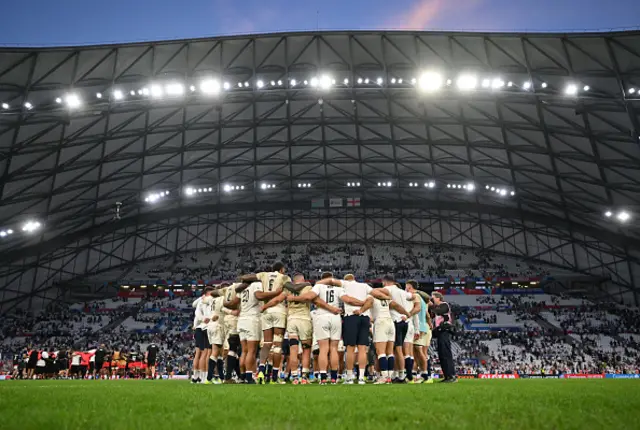 A general view of the inside of the stadium as players of England huddle