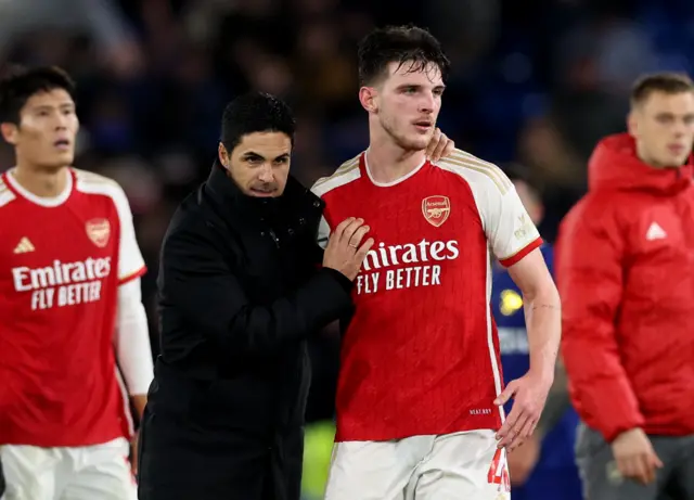 Arteta pats Rice on the shoulder as they walk to salute the fans.