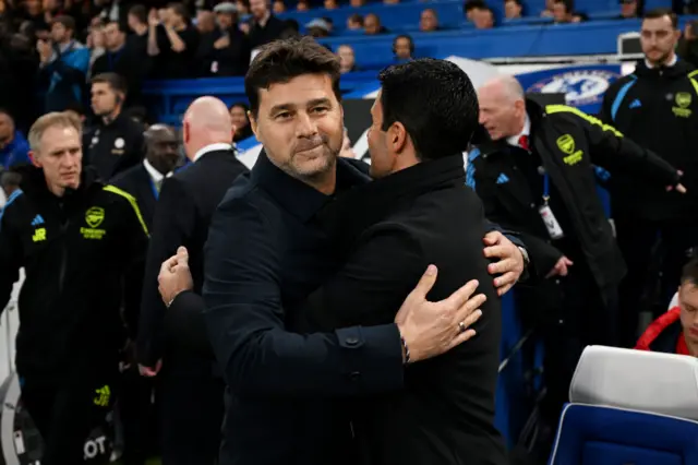 Pochettino and Arteta embrace on the touchline.