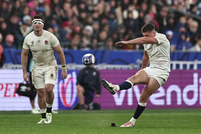 England's fly-half and captain Owen Farrell kicks the ball for a penalty conversion